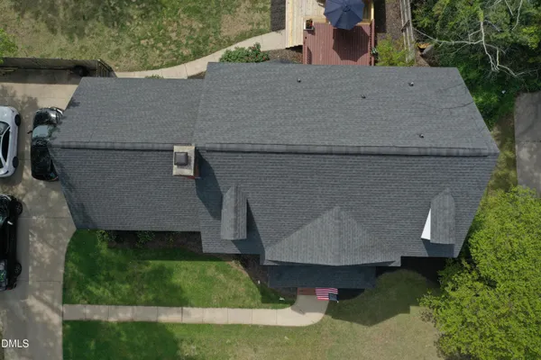 an aerial view of a house with a yard
