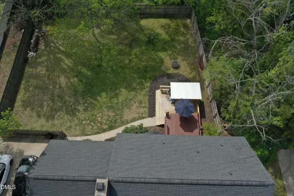 an aerial view of a house with a yard and lake view
