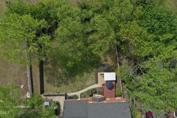 an aerial view of a house with a yard and lake view