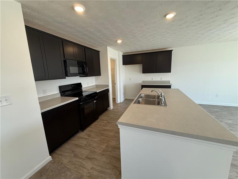 4005 Chakeres Avenue Springfield, OH 45505 - Photo 6 of 19 This kitchen features sleek countertops and ample cabinetry, offering both style and functionality for daily living.
