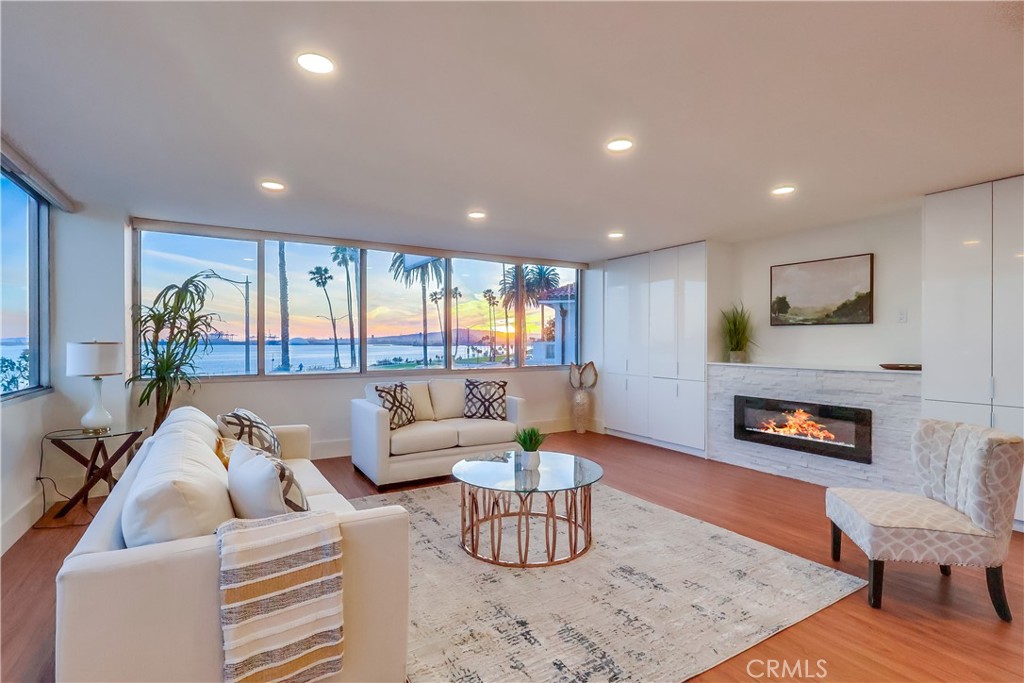 2999 East Ocean Boulevard, Unit 210 Long Beach, CA 90803 - Photo 1 of 48 a living room with furniture and a fireplace