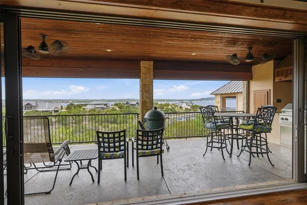 a view of a chairs and table in a balcony