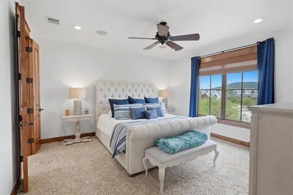 a bedroom with a bed and a chandelier
