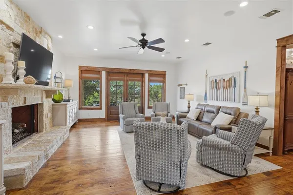 a living room with furniture a flat screen tv and a fireplace