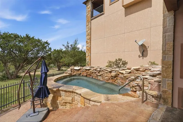 a view of an outdoor dining space with a table and chairs