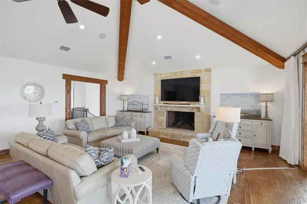 a living room with furniture a fireplace and a flat screen tv