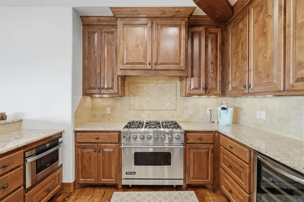 a stove top oven sitting inside of a kitchen
