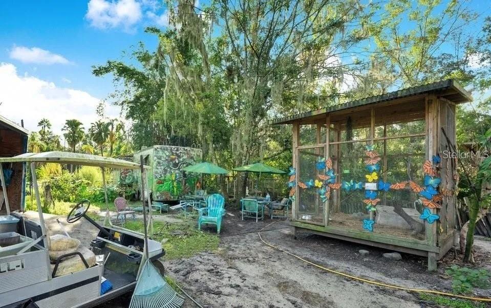 805 Baron Road Orlando, FL 32828 - Photo 7 of 11 a backyard of a house with barbeque oven table and chairs