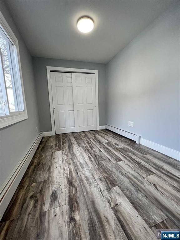 326 70th Street, Unit 2 Guttenberg, NJ 07093 - Photo 10 of 15 an empty room with wooden floor and windows