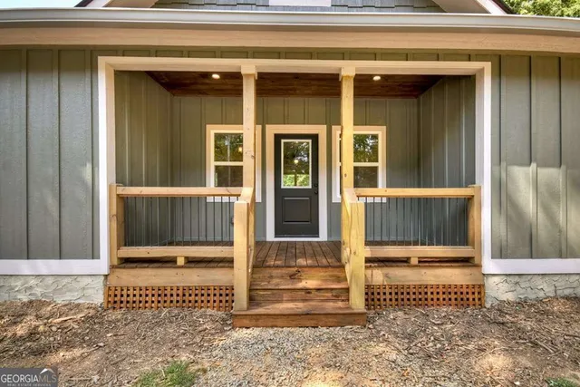 a view of a porch with wooden floor and outdoor space