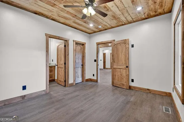 a bathroom with a granite countertop sink a toilet a mirror and shower