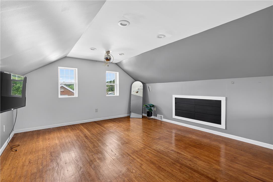 23 Harrison Street Emmaus, PA 18049 - Photo 19 of 28 Hardwood floors and bright windows illuminate this spacious and versatile attic room.