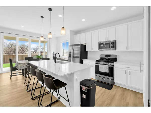 a kitchen with stainless steel appliances kitchen island granite countertop a sink and cabinets