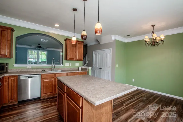a kitchen with kitchen island a sink stove and wooden floor