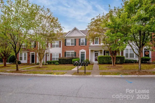 a view of a big house with large trees and a big yard