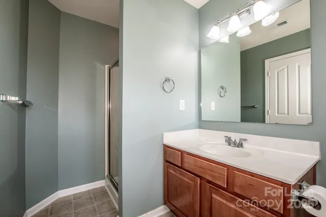 a bathroom with a sink vanity and a mirror