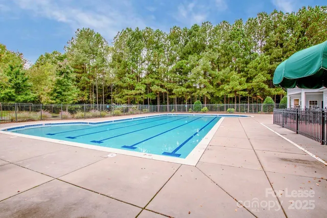 a view of a sign board with large trees