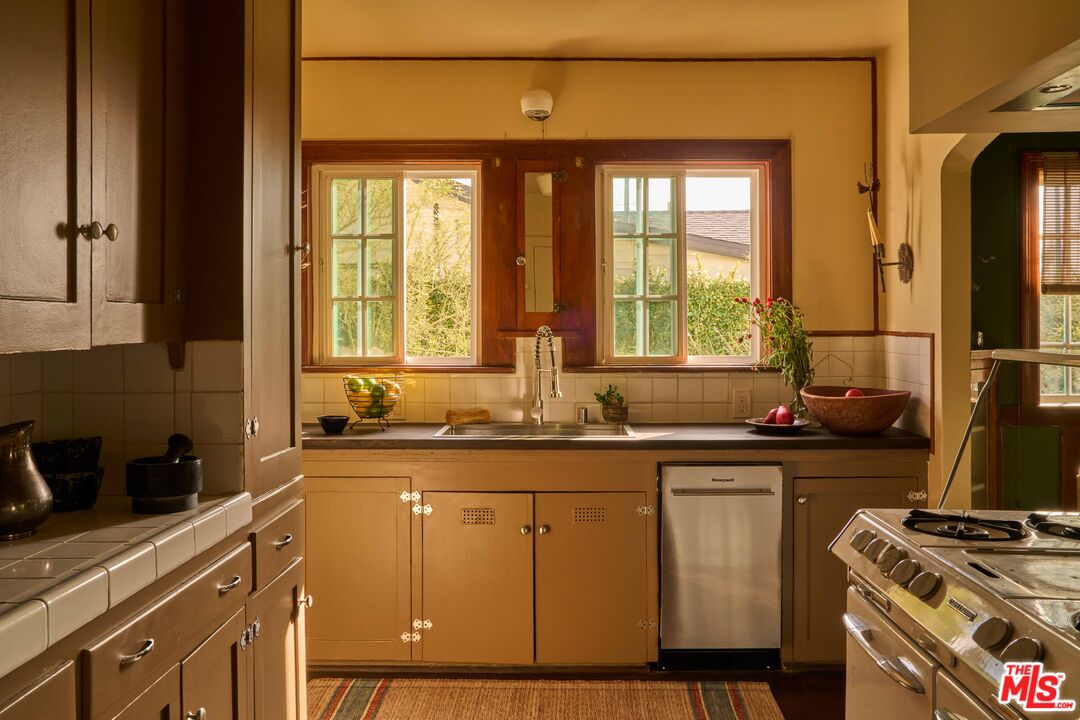 4179 South Van Ness Avenue Los Angeles, CA 90008 - Photo 18 of 44 a kitchen with a sink and cabinets