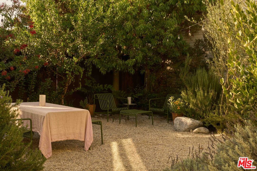 4179 South Van Ness Avenue Los Angeles, CA 90008 - Photo 33 of 44 a view of a patio with table and chairs and potted plants
