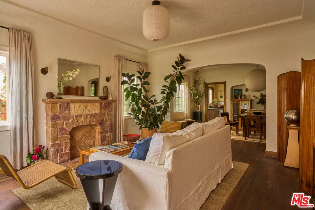 4179 South Van Ness Avenue Los Angeles, CA 90008 - Photo 7 of 44 a living room with furniture a fireplace and chandelier