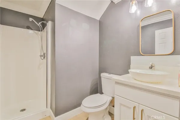 a bathroom with a toilet a sink a vanity and mirror