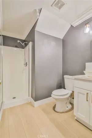 a bathroom with a toilet and a shower