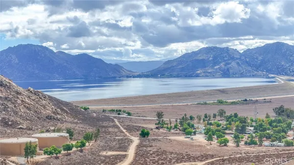 a kitchen with stainless steel appliances kitchen island granite countertop a stove a sink a dining table and chairs