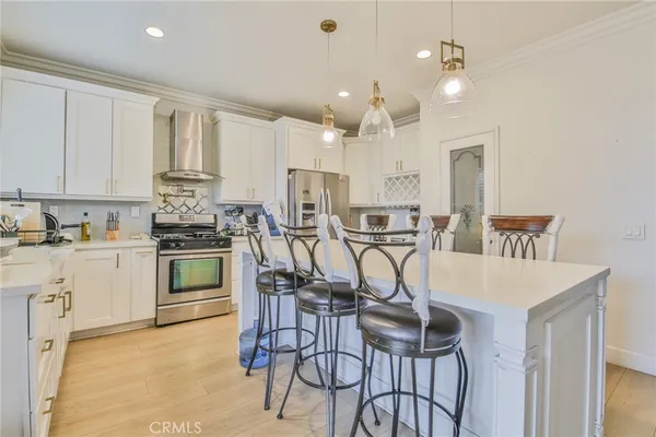 a kitchen with kitchen island a sink stove and refrigerator