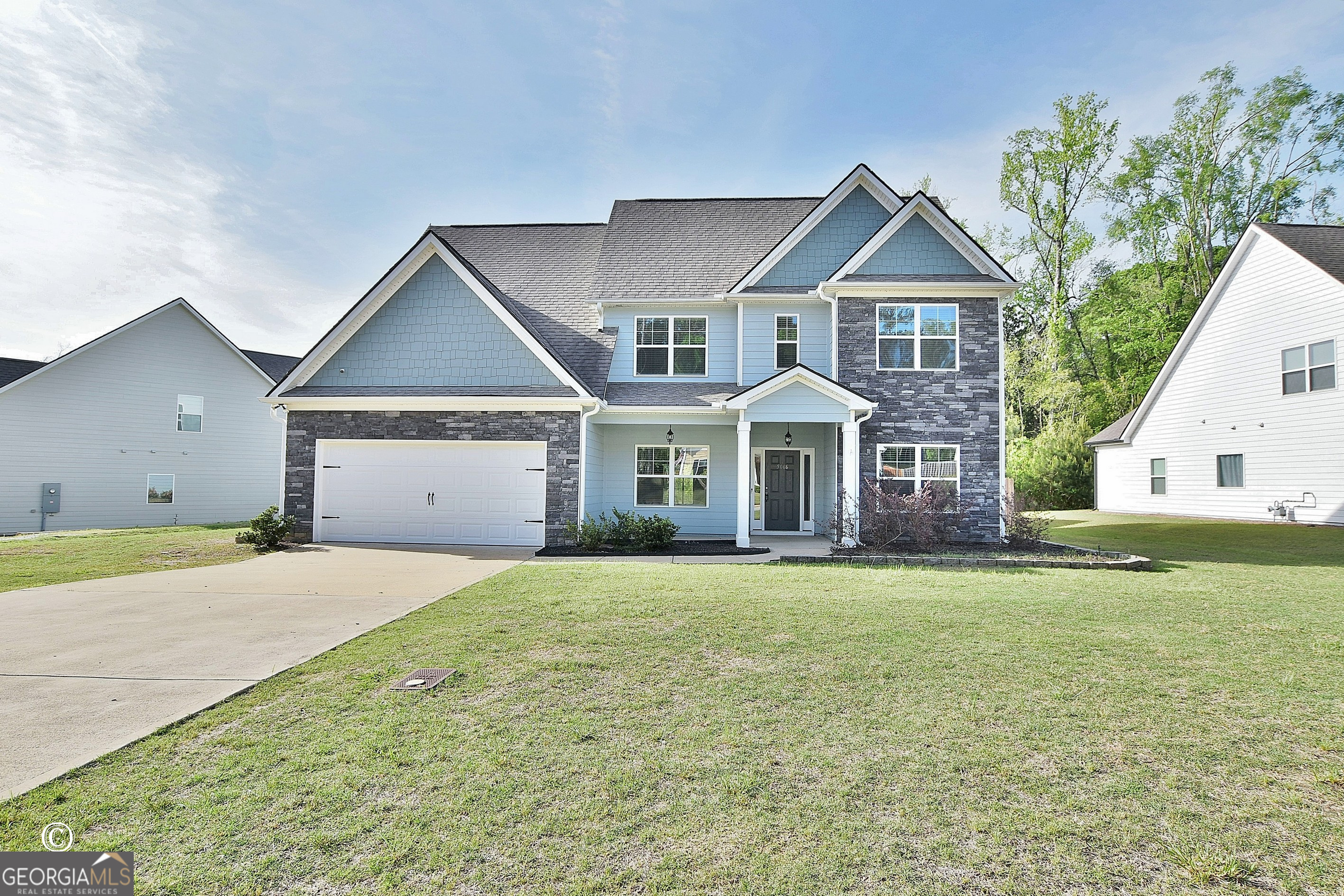 5066 Pond View Court Columbus, GA 31907 - Photo 1 of 30 a front view of a house with a garden and yard