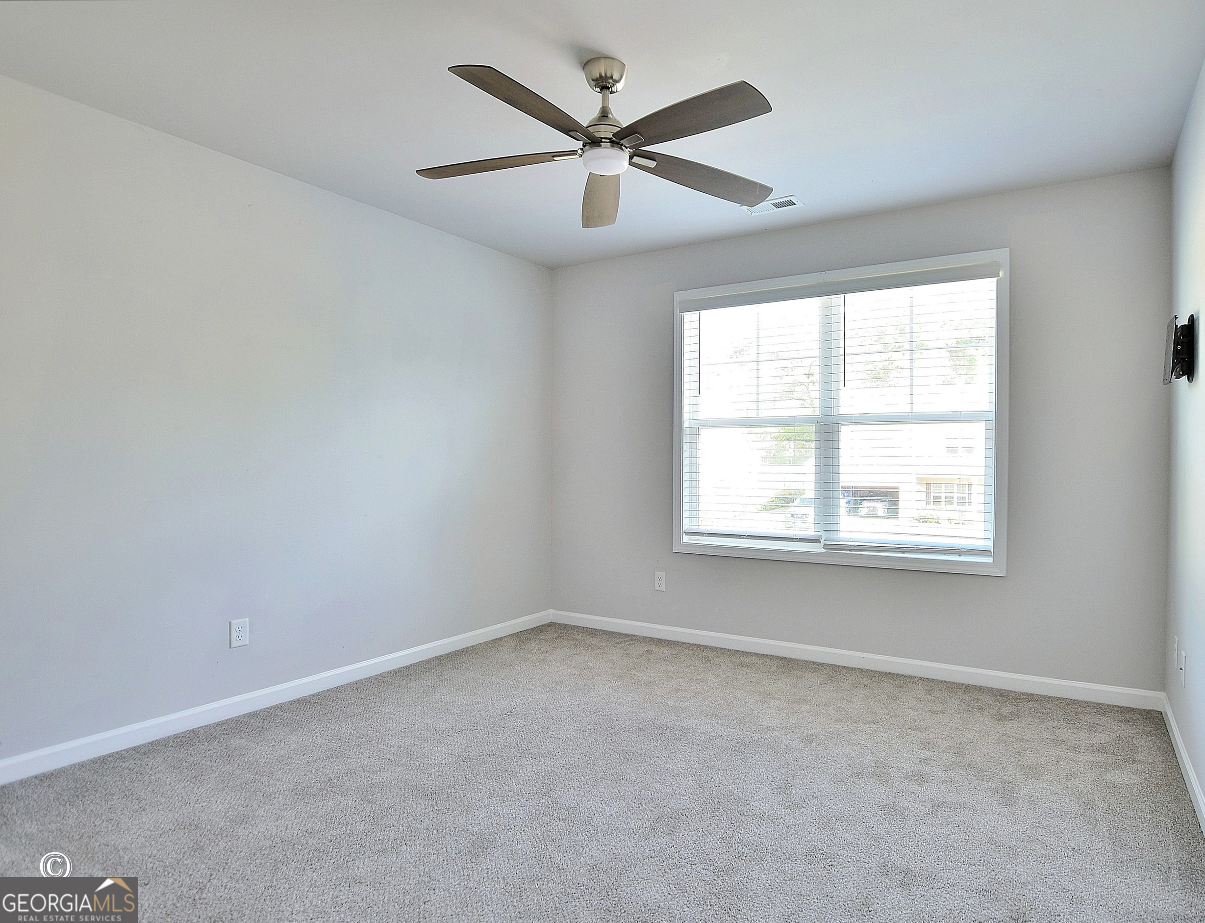 5066 Pond View Court Columbus, GA 31907 - Photo 18 of 30 an empty room with a window and a ceiling fan