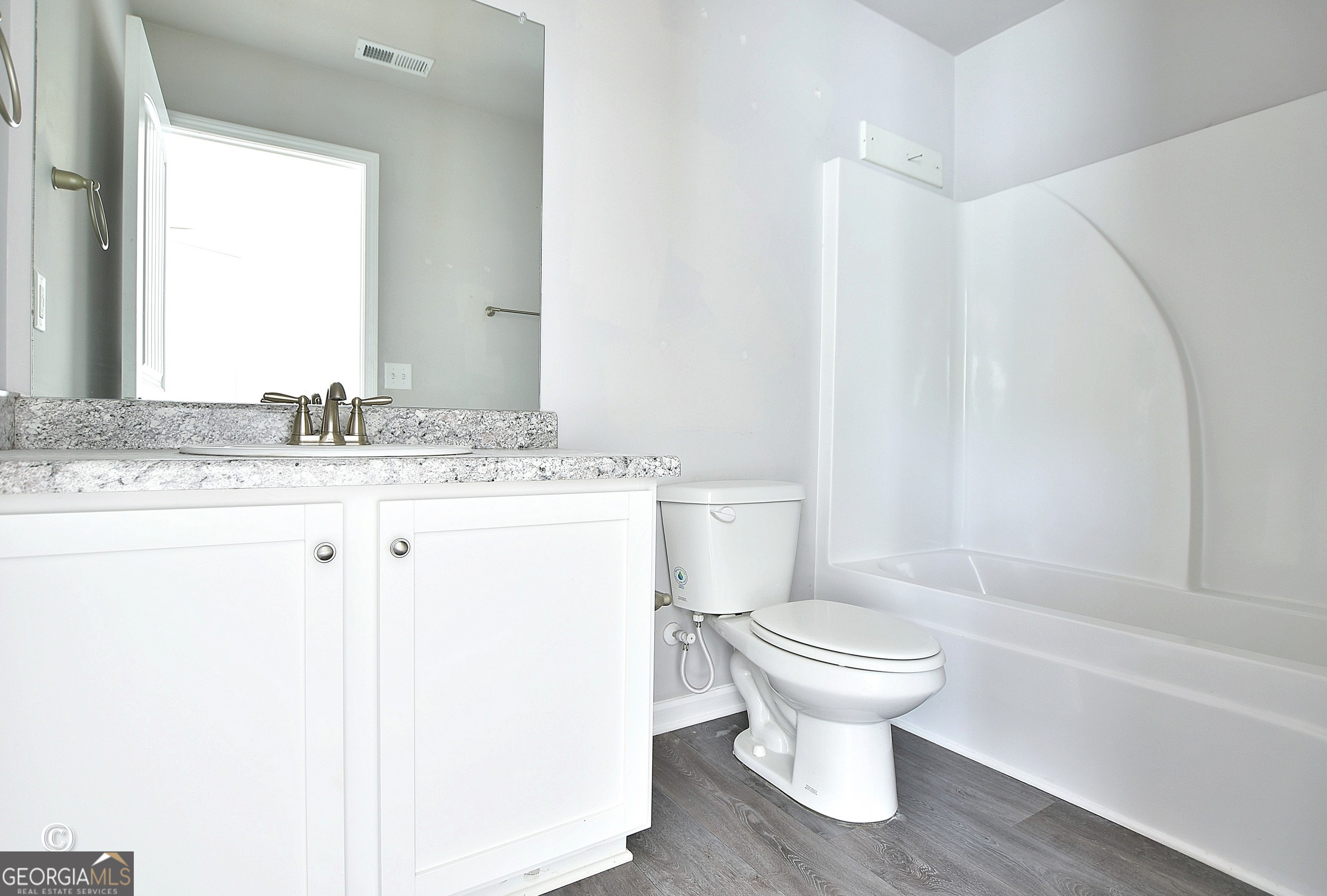 5066 Pond View Court Columbus, GA 31907 - Photo 20 of 30 a bathroom with a granite countertop toilet sink and mirror