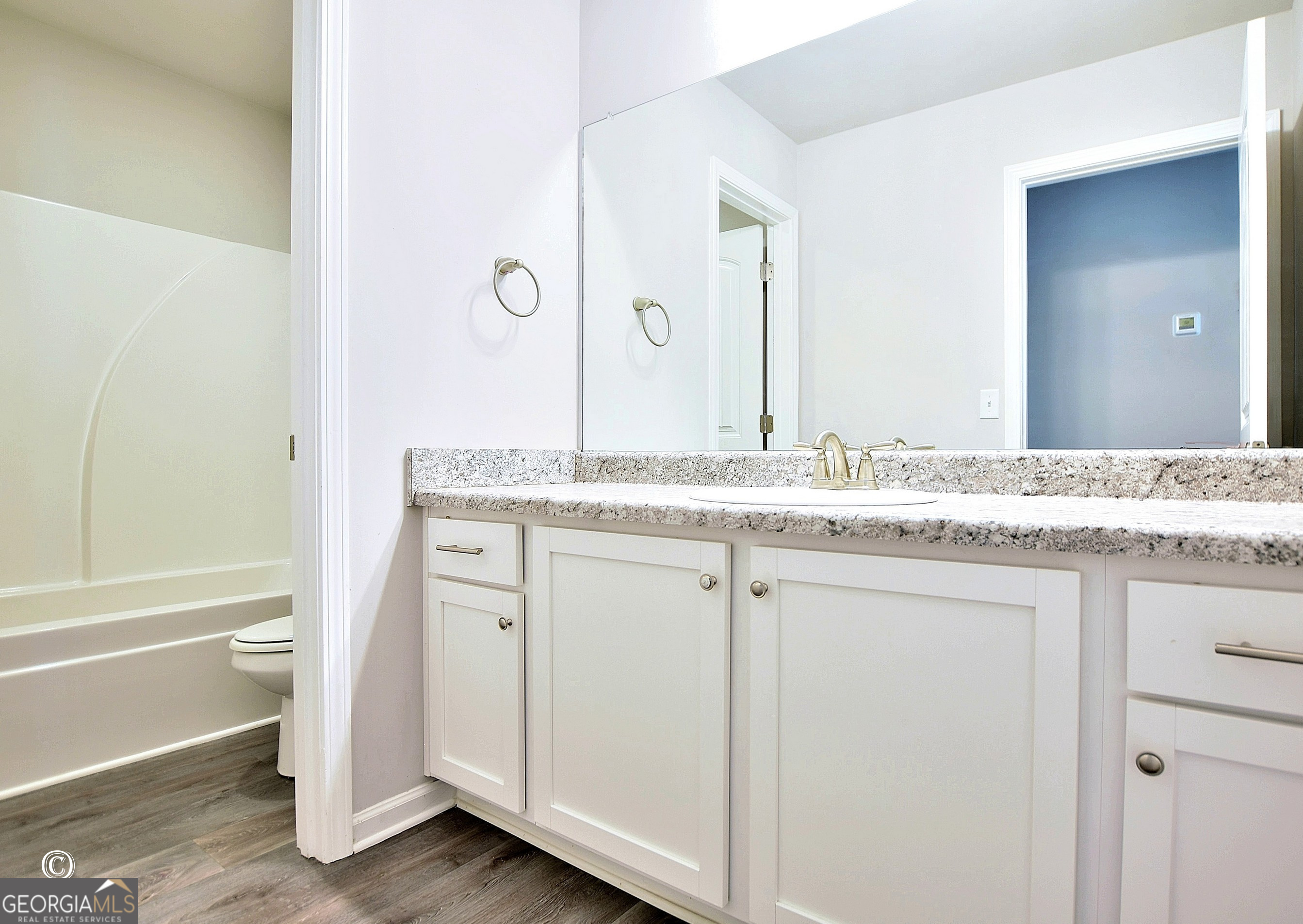 5066 Pond View Court Columbus, GA 31907 - Photo 21 of 30 a bathroom with a granite countertop sink and a mirror