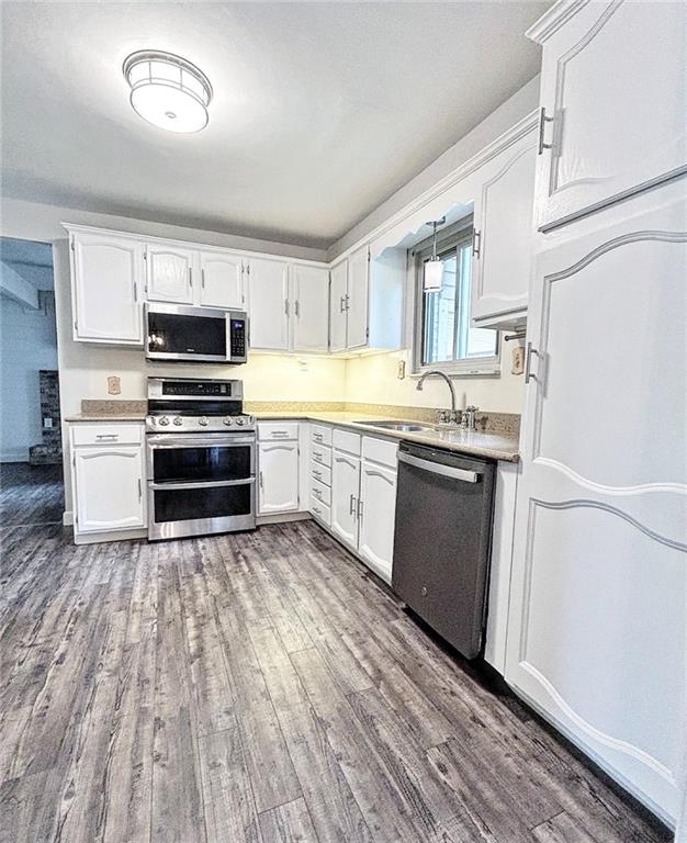 102 Crosslands Road Butler, PA 16002 - Photo 11 of 42 a kitchen with wooden floors and white appliances