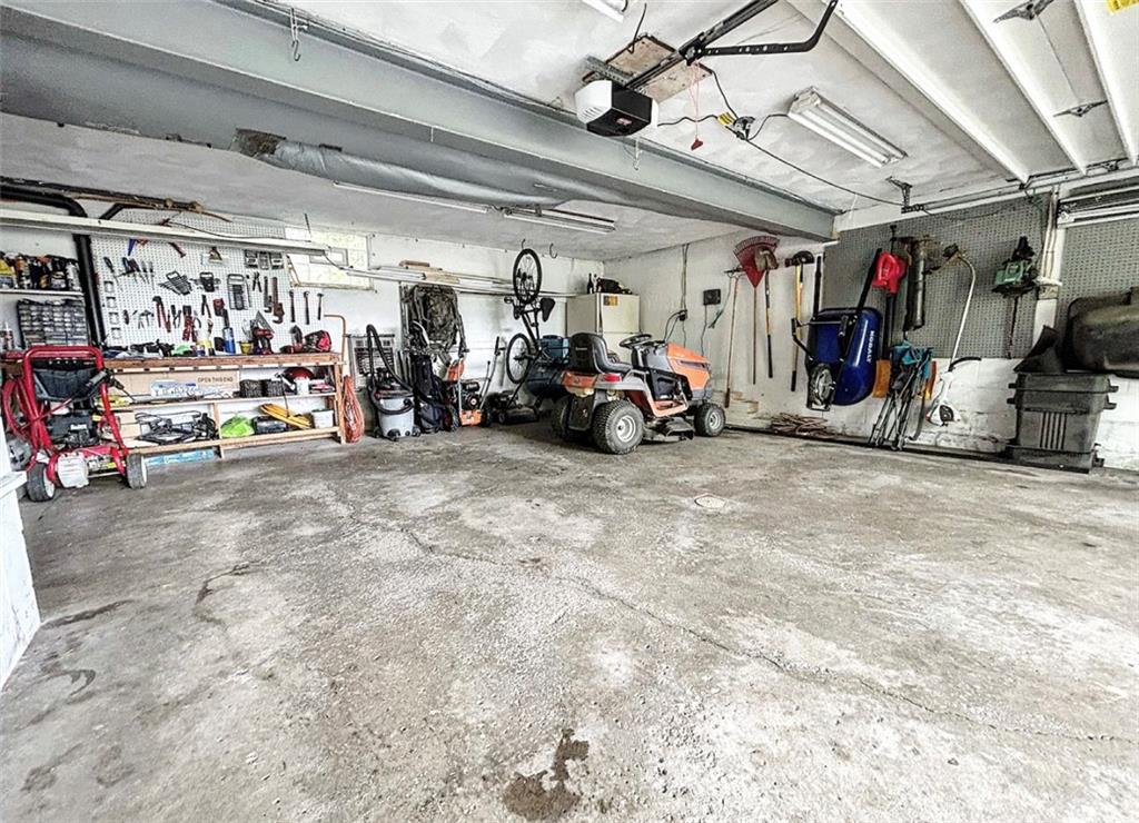 102 Crosslands Road Butler, PA 16002 - Photo 33 of 42 a view of a garage with a bike and car