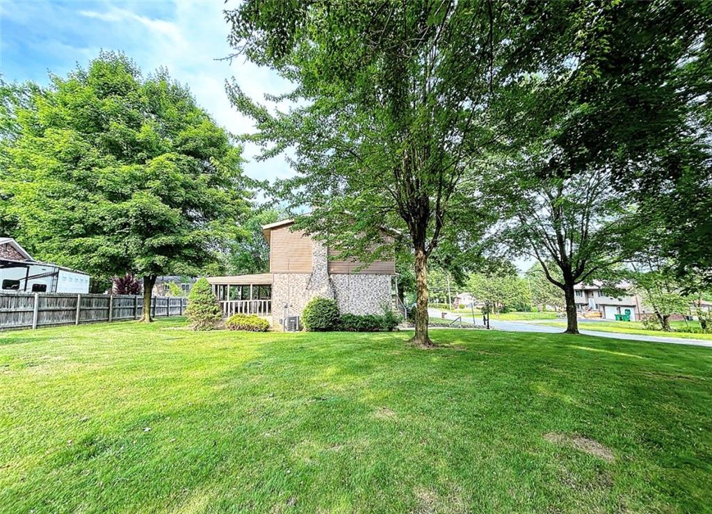 102 Crosslands Road Butler, PA 16002 - Photo 39 of 42 a swimming pool is sitting in a big yard with large trees