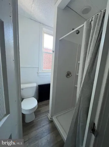 a bathroom with a toilet and a shower