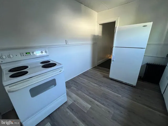 a kitchen with a stove and a refrigerator
