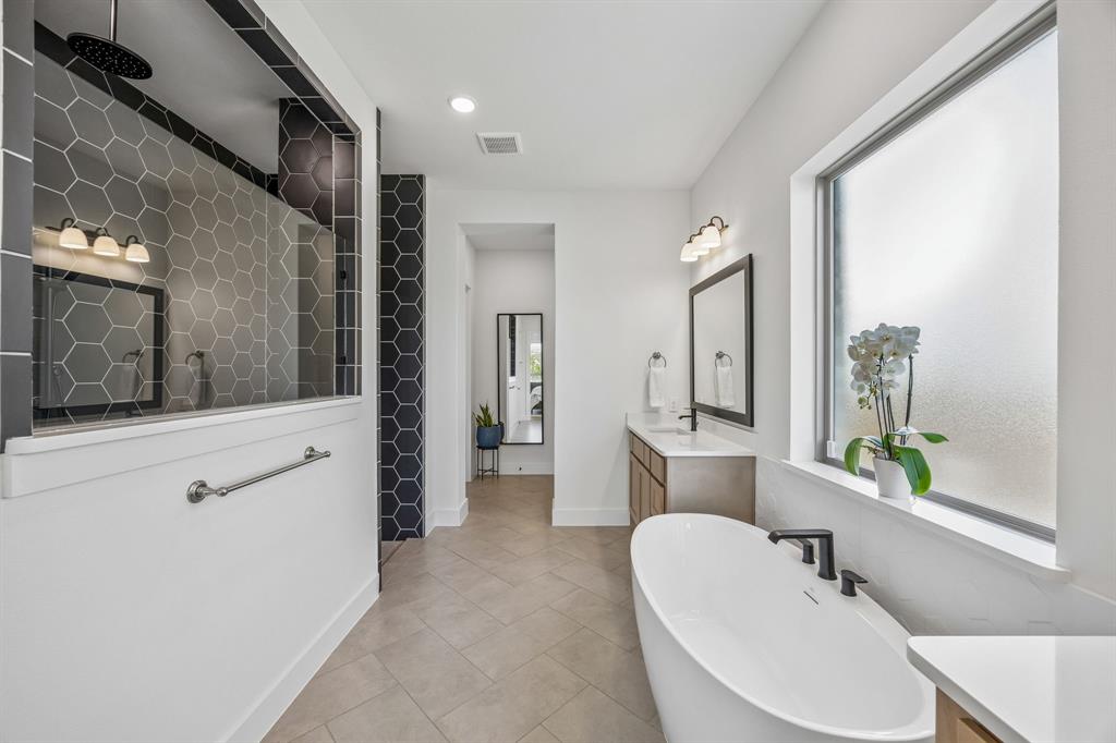 311 Pecan Trail Prosper, TX 75078 - Photo 12 of 39 a spacious bathroom with a sink a mirror a bathtub and shower