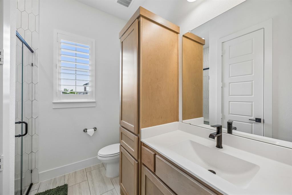 311 Pecan Trail Prosper, TX 75078 - Photo 15 of 39 a bathroom with a sink a toilet and shower