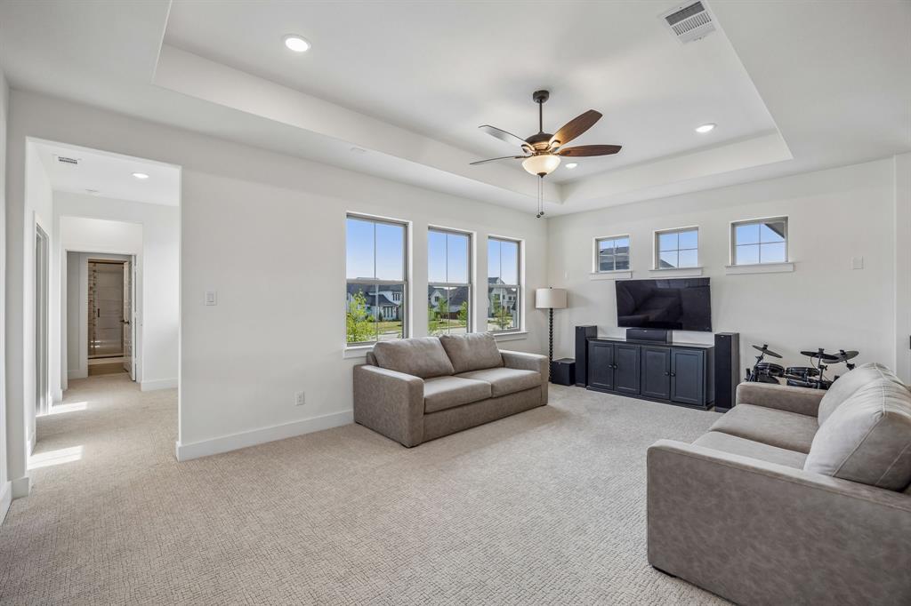 311 Pecan Trail Prosper, TX 75078 - Photo 20 of 39 a living room with furniture a ceiling fan and a window