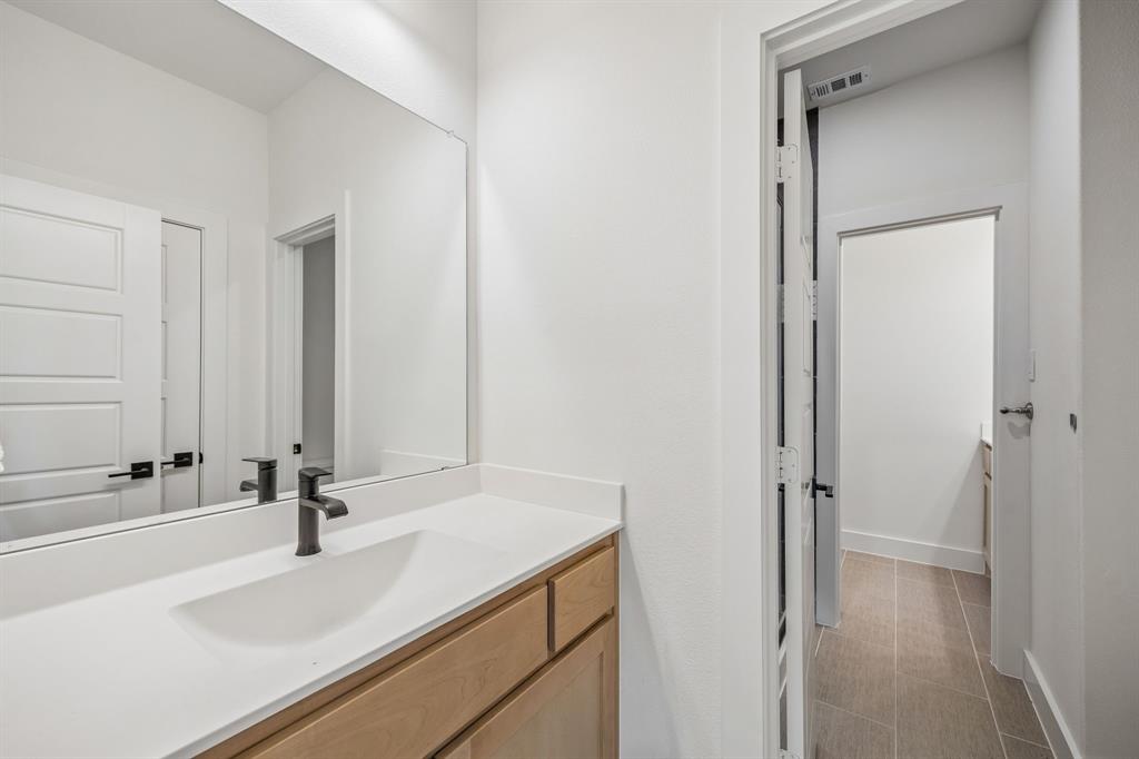 311 Pecan Trail Prosper, TX 75078 - Photo 23 of 39 a bathroom with a sink and a mirror