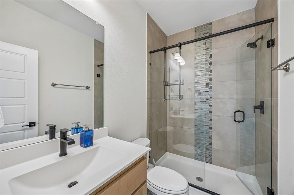 311 Pecan Trail Prosper, TX 75078 - Photo 25 of 39 a bathroom with a sink a toilet and shower