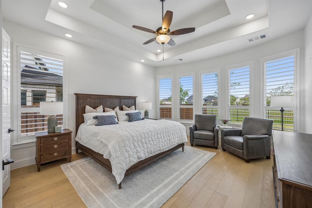 311 Pecan Trail Prosper, TX 75078 - Photo 8 of 39 a bedroom with a bed couches and a flat tv screen