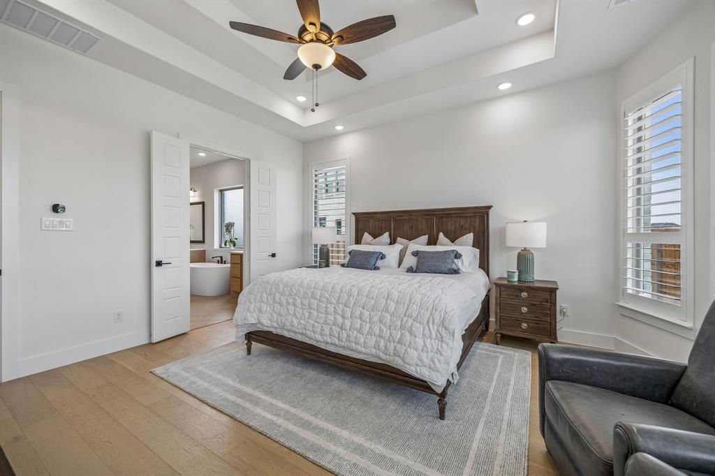 311 Pecan Trail Prosper, TX 75078 - Photo 9 of 39 a bedroom with a large bed a couch and chandelier
