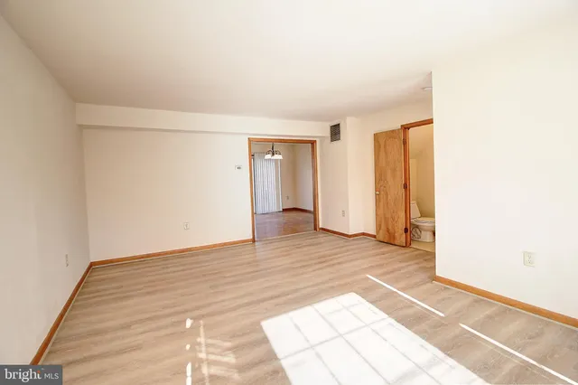 a view of an empty room and wooden floor