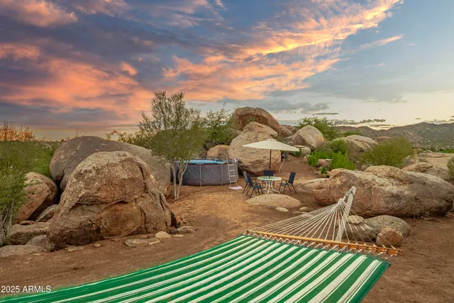 a view of a house with a backyard