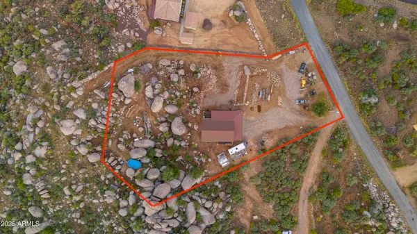 a view of a wooden house with a mountain and a forest
