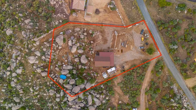 a view of a wooden house with a mountain and a forest