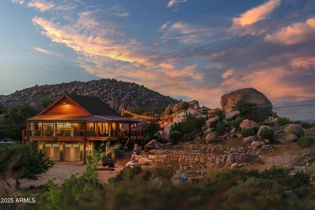 a kitchen with stainless steel appliances granite countertop a table chairs refrigerator and sink