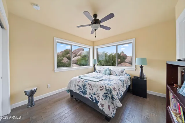 a kitchen with kitchen island granite countertop a table chairs sink and cabinets